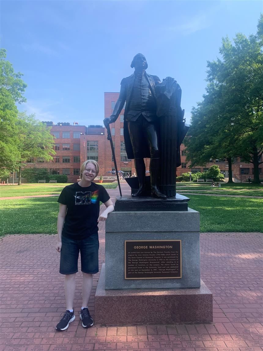 Thomas Gaita next to a statue of George Washington; property of Thomas Gaita